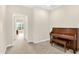 Light-filled living room featuring a piano and neutral carpet at 6691 Beekman Pl, Zionsville, IN 46077