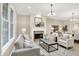 Cozy living room features a fireplace, neutral paint, and views into the dining room at 6691 Beekman Pl, Zionsville, IN 46077