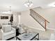 Open-concept living area with views into the dining room; neutral paint and hardwood floors at 6691 Beekman Pl, Zionsville, IN 46077