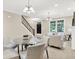 Spacious living area open to the dining room, featuring a staircase and bright natural light at 6691 Beekman Pl, Zionsville, IN 46077