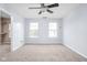 Large bedroom with neutral carpet, paint, a ceiling fan and two windows at 6955 Long Run Dr, Indianapolis, IN 46268