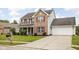Charming two-story home with brick and vinyl siding, red shutters, covered front porch, and attached two car garage at 6955 Long Run Dr, Indianapolis, IN 46268