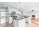 Kitchen open to the living room with white cabinets, an island and granite countertops at 6955 Long Run Dr, Indianapolis, IN 46268