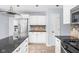 Kitchen with granite countertops, stainless steel appliances, tile backsplash, and white cabinets at 6955 Long Run Dr, Indianapolis, IN 46268