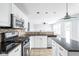 Bright kitchen with granite countertops, stainless steel appliances and white cabinets at 6955 Long Run Dr, Indianapolis, IN 46268