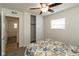 Bright bedroom features a closet, ceiling fan, and view into another room at 717 Berkeley Dr, Shelbyville, IN 46176