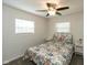 Cozy bedroom with floral bedding, natural light from the window, and stylish ceiling fan at 717 Berkeley Dr, Shelbyville, IN 46176