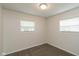 An empty bedroom, filled with sunlight and a carpeted floor at 717 Berkeley Dr, Shelbyville, IN 46176