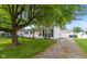 Charming single-story home with a well-maintained front yard and detached garage at 717 Berkeley Dr, Shelbyville, IN 46176