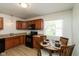 Cozy kitchen with wood cabinets, modern appliances, and an eat-in dining table at 717 Berkeley Dr, Shelbyville, IN 46176