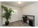 A practical office space with ample natural light and sleek desk, complemented by a decorative plant at 717 Berkeley Dr, Shelbyville, IN 46176