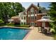 Beautiful backyard with a pool, patio set, and landscaped greenery, perfect for outdoor living at 7341 Washington Blvd, Indianapolis, IN 46240