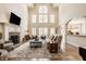 Spacious living room with a fireplace, large windows, and comfortable seating at 7341 Washington Blvd, Indianapolis, IN 46240