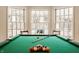 Close-up of a pool table in a bright room with large windows offering natural light at 7341 Washington Blvd, Indianapolis, IN 46240