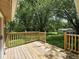 Back deck with wood railings overlooking the grassy yard and tree line at 7434 N Green Meadows, Fairland, IN 46126