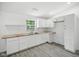 Bright kitchen features white cabinets, stainless sink and faucet, and light wood countertops at 7434 N Green Meadows, Fairland, IN 46126