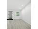 Bright and airy living room with modern gray wood flooring and a large front door at 7434 N Green Meadows, Fairland, IN 46126