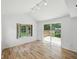 Bright living room featuring wood floors, natural light, and access to the outdoor patio at 7434 N Green Meadows, Fairland, IN 46126
