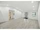 Open living area showcasing gray wood flooring, white walls, recessed lighting and a bathroom at 7434 N Green Meadows, Fairland, IN 46126