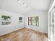 Bright living room featuring wood floors, natural light, and access to the outdoor patio at 7434 N Green Meadows, Fairland, IN 46126