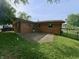 Brick home with concrete patio, fenced backyard and well-manicured lawn, ideal for outdoor living at 771 Doran Ave, Shelbyville, IN 46176