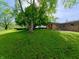 Lush backyard featuring mature trees and a well-maintained lawn, creating a serene outdoor space at 771 Doran Ave, Shelbyville, IN 46176