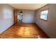 Bedroom with hardwood flooring, a view to the kitchen area, and a light gray painted walls at 771 Doran Ave, Shelbyville, IN 46176