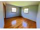 Inviting bedroom featuring hardwood floors and natural light from two windows at 771 Doran Ave, Shelbyville, IN 46176