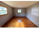 Empty bedroom with hardwood floors, gray walls, and natural light from two windows at 771 Doran Ave, Shelbyville, IN 46176