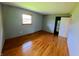 Bedroom with refinished hardwood floors, light-filled window and neutral colored walls at 771 Doran Ave, Shelbyville, IN 46176