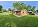 Well-maintained brick home with lush landscaping, complemented by a detached garage and driveway at 771 Doran Ave, Shelbyville, IN 46176