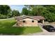 Well-maintained brick home, detached garage, and a black vehicle parked in the driveway at 771 Doran Ave, Shelbyville, IN 46176