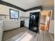 Functional kitchen with a refrigerator and white cabinets, plus wood-look vinyl flooring at 771 Doran Ave, Shelbyville, IN 46176