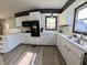 Bright kitchen featuring white cabinetry, modern appliances, and wood-look flooring at 771 Doran Ave, Shelbyville, IN 46176
