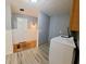 Well-lit laundry room features modern washer and dryer with grey paint and tile flooring at 771 Doran Ave, Shelbyville, IN 46176