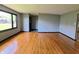 Spacious living room with hardwood floors, light gray walls, and natural light at 771 Doran Ave, Shelbyville, IN 46176