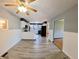 Spacious open floorplan, light gray walls, wood-look flooring, connecting kitchen and living spaces at 771 Doran Ave, Shelbyville, IN 46176