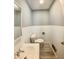 This powder room features a sleek toilet, sink, mirror and flooring at 771 Doran Ave, Shelbyville, IN 46176
