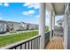 Charming community view from private balcony with black iron railing and white pillars on a sunny day with blue skies at 776 Templeton Dr, Carmel, IN 46032