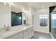 Bathroom features double vanity, large mirror, and green tiled shower, offering style and comfort at 776 Templeton Dr, Carmel, IN 46032