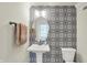 Stylish powder room features designer wallpaper, pedestal sink, decorative mirror and modern fixtures at 776 Templeton Dr, Carmel, IN 46032