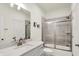 Well-lit bathroom featuring gray tiled shower, modern vanity with sink, and a toilet, blending style and functionality at 776 Templeton Dr, Carmel, IN 46032