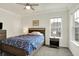 Well-lit bedroom showcasing ceiling fan, carpet flooring, neutral paint, large window and closet for ample storage at 776 Templeton Dr, Carmel, IN 46032