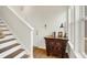 Inviting entryway with wooden stairs, wood floors, and decorative antique table at 776 Templeton Dr, Carmel, IN 46032