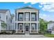 Charming two-story home with large front porch, white columns, fenced in yard and blue siding at 776 Templeton Dr, Carmel, IN 46032