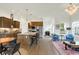 Open kitchen featuring an island with granite countertops, stainless steel appliances, and hardwood floors at 776 Templeton Dr, Carmel, IN 46032