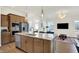 Modern kitchen features stainless appliances, granite countertops, and an island open to the living area at 776 Templeton Dr, Carmel, IN 46032