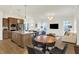 Open-concept kitchen and dining area with stainless appliances, granite countertops and views to the living room at 776 Templeton Dr, Carmel, IN 46032