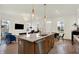 Open kitchen featuring an island with granite countertops, stainless steel appliances, and hardwood floors at 776 Templeton Dr, Carmel, IN 46032