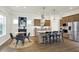 Bright eat-in kitchen with stainless appliances, granite countertops, breakfast bar, and adjacent dining area at 776 Templeton Dr, Carmel, IN 46032